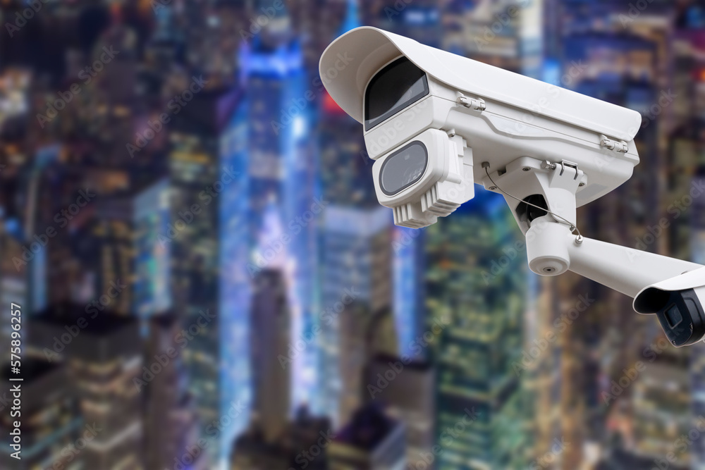 CCTV monitoring, security cameras. Backdrop with views of the city during twilight.