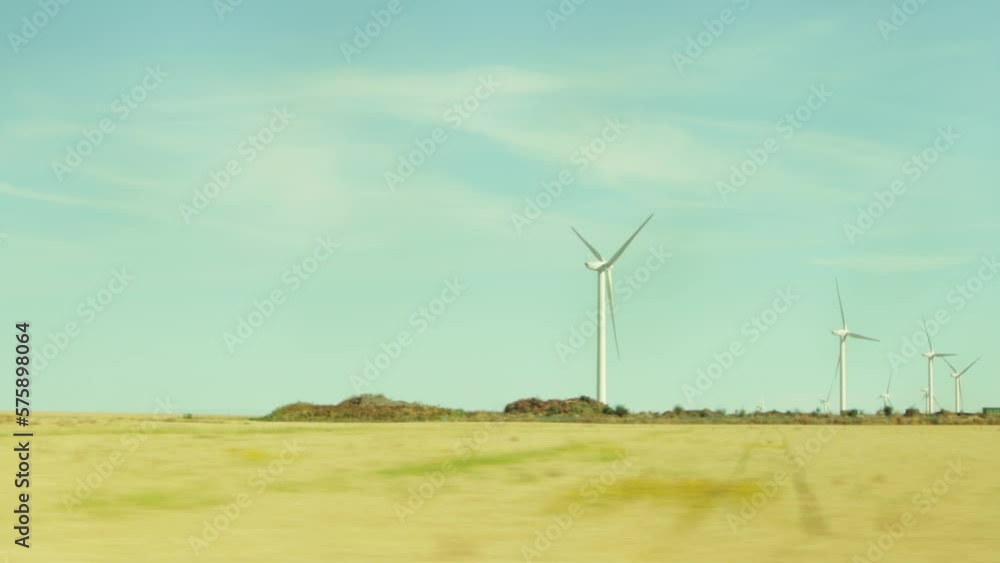 video from the car the road through the field, around the yellow grass and in the distance a lot of wind turbines can be seen, generating ecological electricity video from the car the road through the field, around the yellow grass and in the distance a lot of wind turbines can be seen, generating ecological electricity