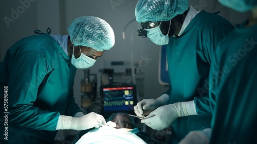 African American professional team of doctors and surgeons processing surgical operation in operating room modern hospital emergency department