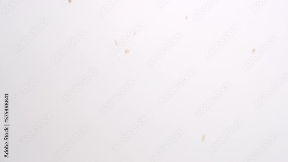 Brown sugar clumps falling in slow motion on white studio backdrop in 4k Brown sugar clumps falling in slow motion on white studio backdrop in 4k
