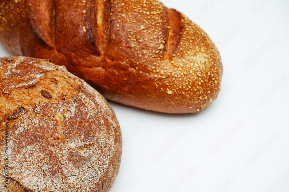 Close-Up Of Bread On White Background. Food, baking and cooking concept - close up of bread