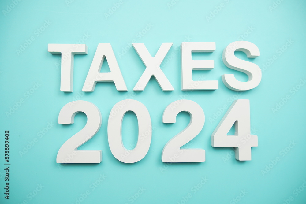 Taxes 2024 alphabet letters on blue background Taxes 2024 alphabet letters on blue background