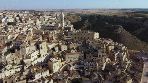 Wallpaper Mural Aerial footage of Sassi di Matera in Basilicata, South Italy.Drone view of Sasso Caveoso, old city houses carved in rock caves, bell tower of Cathedral, a Unesco World Heritage site, from above Torontodigital.ca