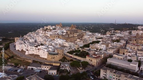 Wallpaper Mural Aerial sunset panoramic drone footage of Ostuni - La Citta Bianca (white city), Puglia, Italy. View of walls, Cathedral, Porta Nova, medieval historic old town landmark tourist destination from above. Torontodigital.ca