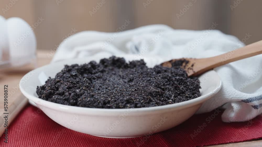 There are white eggs on the table and a full plate with poppy seeds, a close-up panorama. There are white eggs on the table and a full plate with poppy seeds, a close-up panorama.