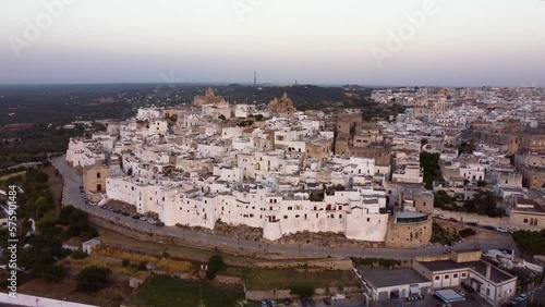 Wallpaper Mural Aerial panoramic drone footage of Ostuni - La Citta Bianca (white city), Puglia, Italy at sunset. View of Cathedral, Porta Nova, the medieval historic old town landmark tourist destination from above. Torontodigital.ca