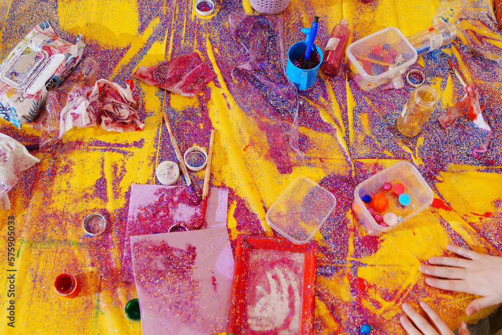 Fototapeta premium yellow tablecloth on a table scattered with sequins. 