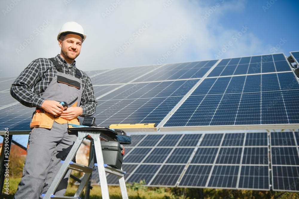 Solar power plant worker checks the condition of the panels