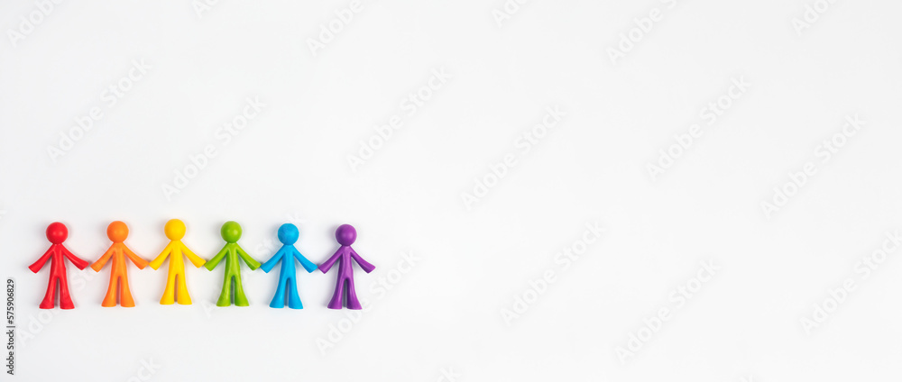 Multicoloured figurines of men on a light-coloured background . Concept of family, society, non-traditional relationships. Multicoloured figurines of men on a light-coloured background . Concept of family, society, non-traditional relationships.