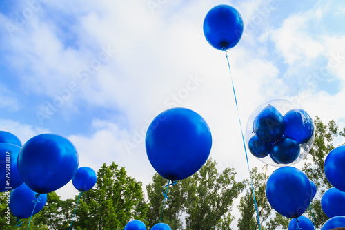 Balloons released into the sky on a festive day.