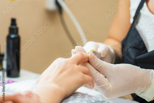 Hands close-up in a beauty salon on a manicure. Background, selective focus