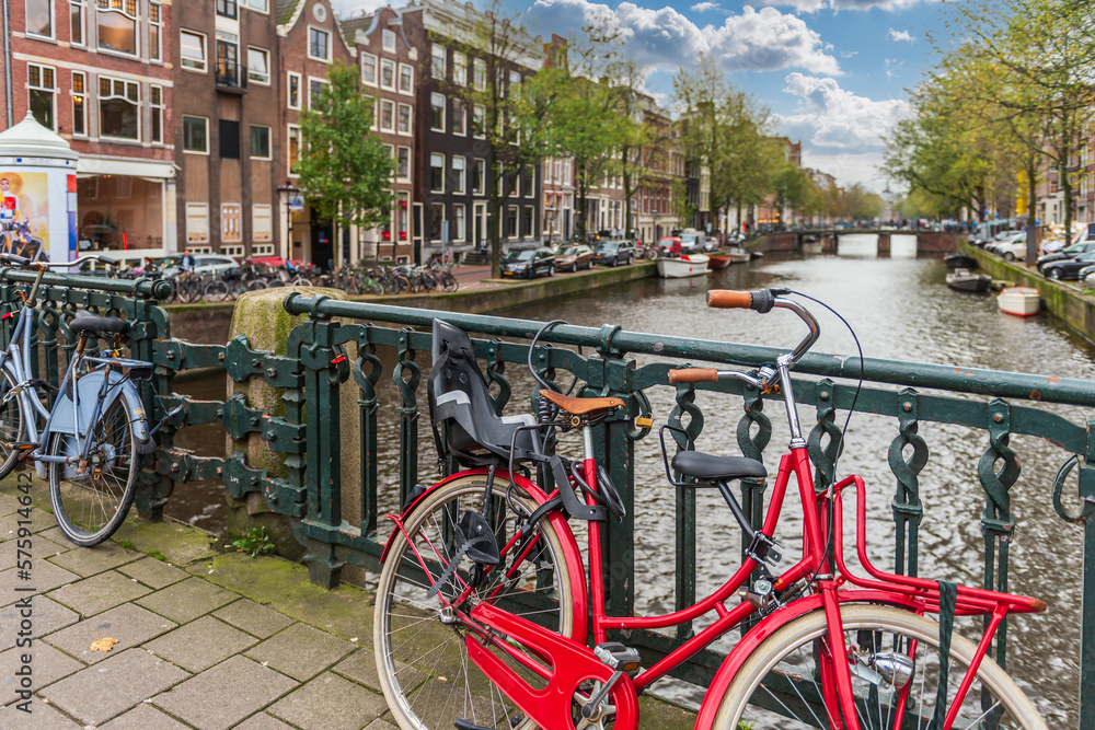 Red bicycle on a bridge in Amsterdam in Holland in the Netherlands