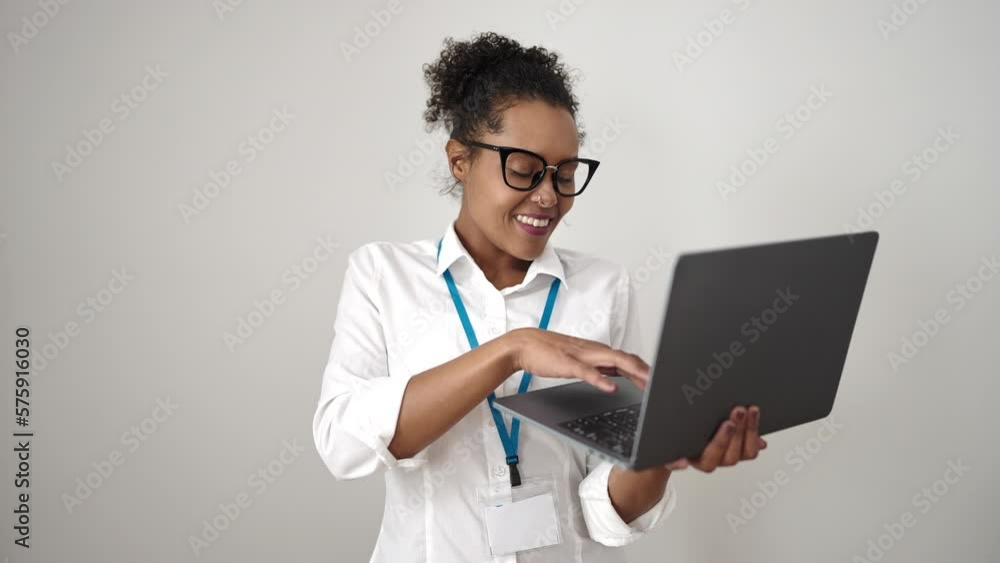 African american woman smiling confident using laptop over isolated white background African american woman smiling confident using laptop over isolated white background