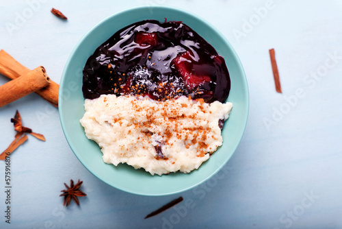 Typical Peruvian dessert: rice pudding and purple mazamorra on a light blue background.