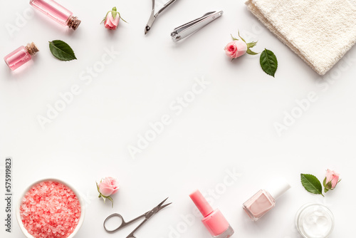 Manicure scissor and hands care cosmetics set with flowers.