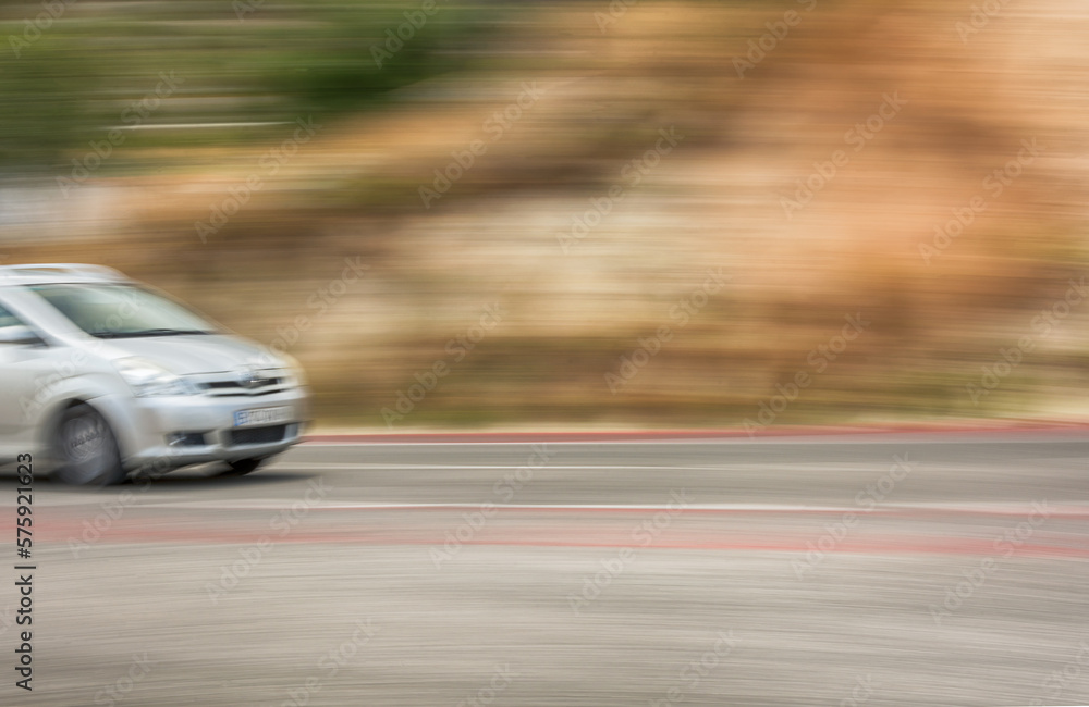 The car is driving at high speed on the autobahn. Motion blur. Copy-space.