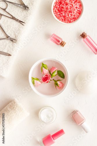 Hands and nail care cosmetic set with pink roses flowers.