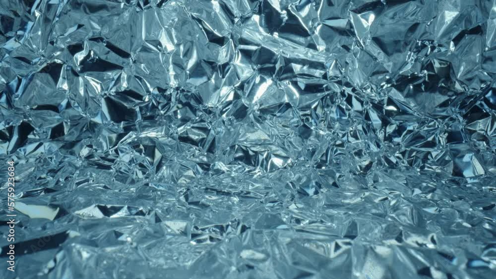 Extreme close-up glide dolly inside shot of blue aluminium foil tunnel ice cave glacier imitation, macro shiny crumpled metal texture shot with laowa probe lens, mashed metal paper abstract pattern Extreme close-up glide dolly inside shot of blue aluminium foil tunnel ice cave glacier imitation, macro shiny crumpled metal texture shot with laowa probe lens, mashed metal paper abstract pattern