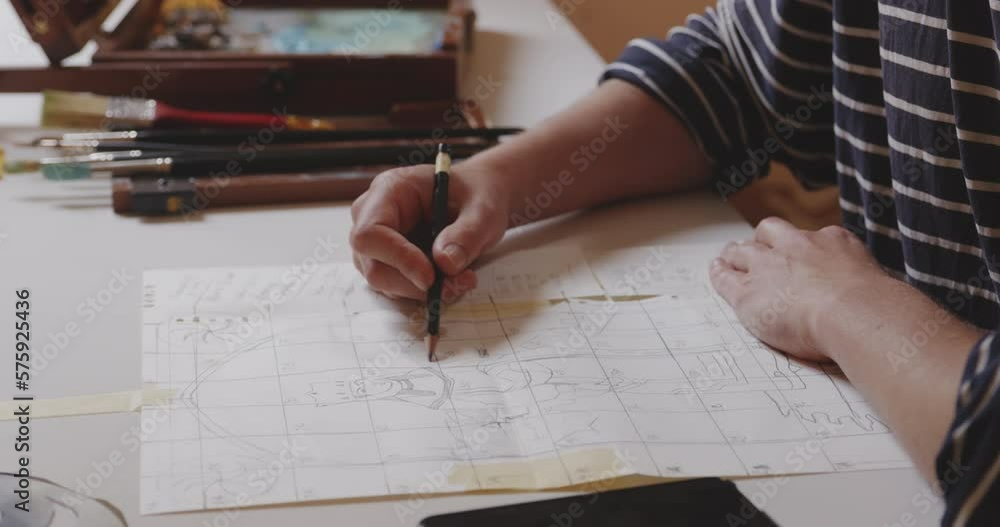 Drawing an illustration of female figure on squared paper with pencil. Drawing an illustration of female figure on squared paper with pencil.