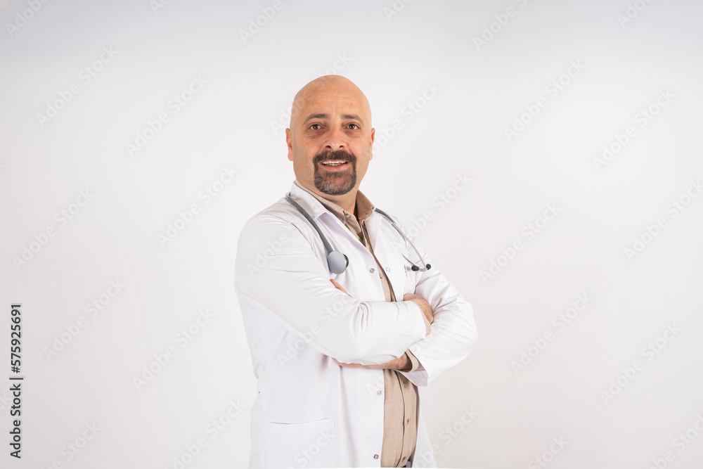 Posing doctor, portrait of caucasian posing doctor. Crossed arms smiling and confident. Looking camera. Copy space. Wearing hospital professional uniform with stethoscope. Bald, bearded handsome man.