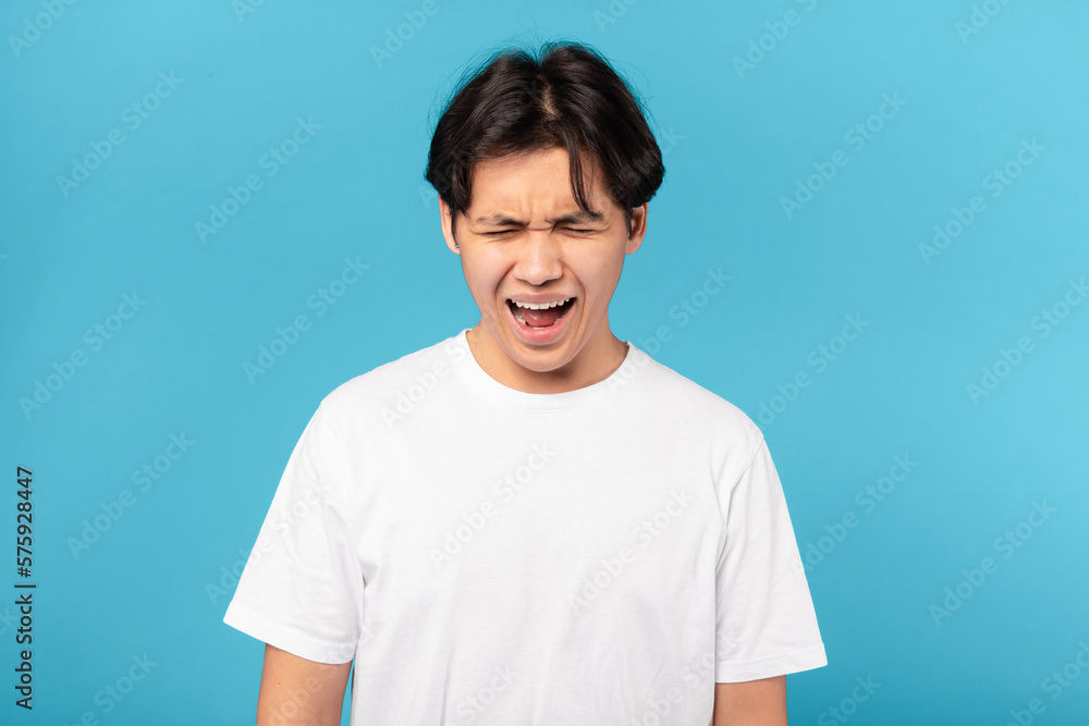 Sad Asian Teen Guy Shouting Loudly Crying Over Blue Background