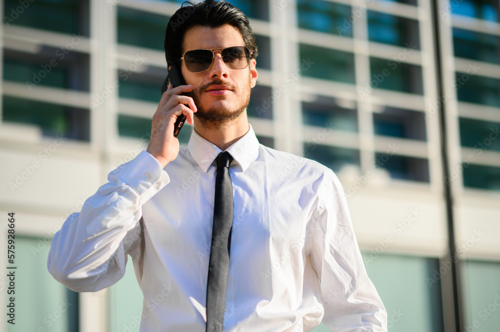 Young manager on the phone outdoor in an urban setting Young manager on the phone outdoor in an urban setting