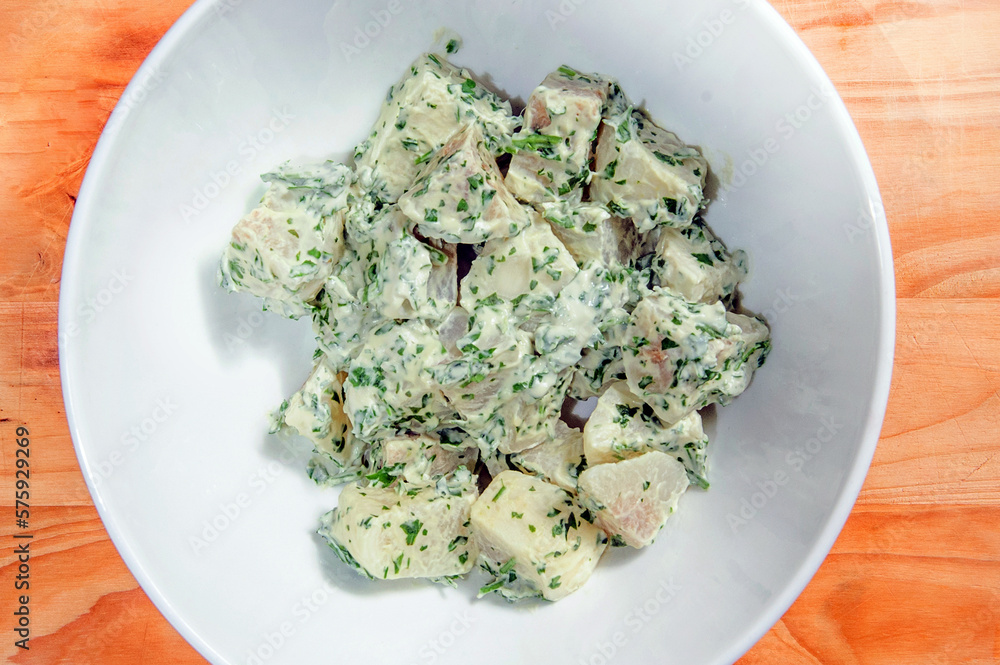 Potato salad with mustard seeds and white filling in rustic style