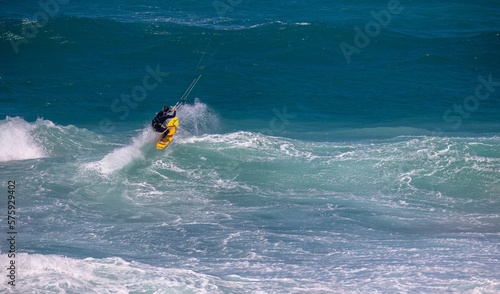 Kiteboarder heads out to wave