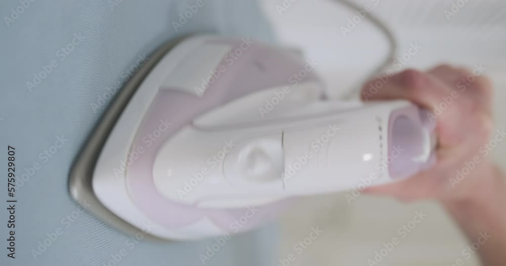 Shaking iron, micro stroking, vertical video. Front view, close-up. Funny iron movement. Shaking iron, micro stroking, vertical video. Front view, close-up. Funny iron movement.