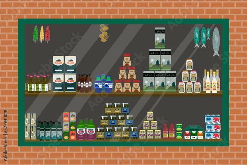 Shop window with products. View from the street. Goods in different packages. Canned food, jars, fish, churchkhela, oil, juice, pasta, onions, sauces, pickled cucumbers, cereals, cereals, drinks.