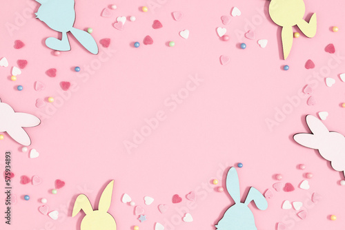 Easter holiday composition. Easter decorations, colorful sugar candy sprinkles isolated on pastel pink background. Easter concept. Flat lay, top view, copy space 