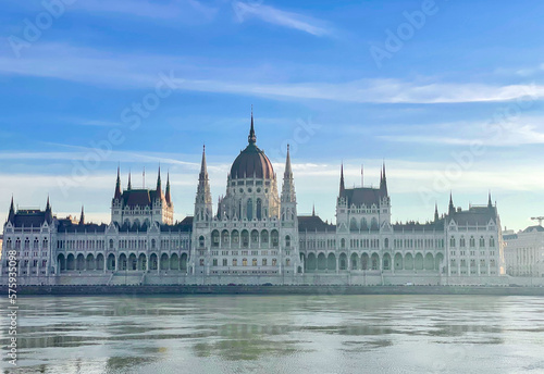 The Budapest Parliament building at a foggy morning with the Danube in the foreground