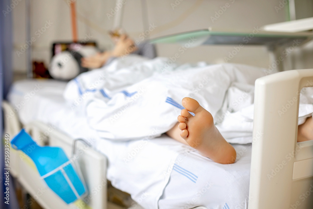 Preteen child, boy, lying in hospital with fractured thoracic spine, vertebralis Preteen child, boy, lying in hospital with fractured thoracic spine, vertebralis