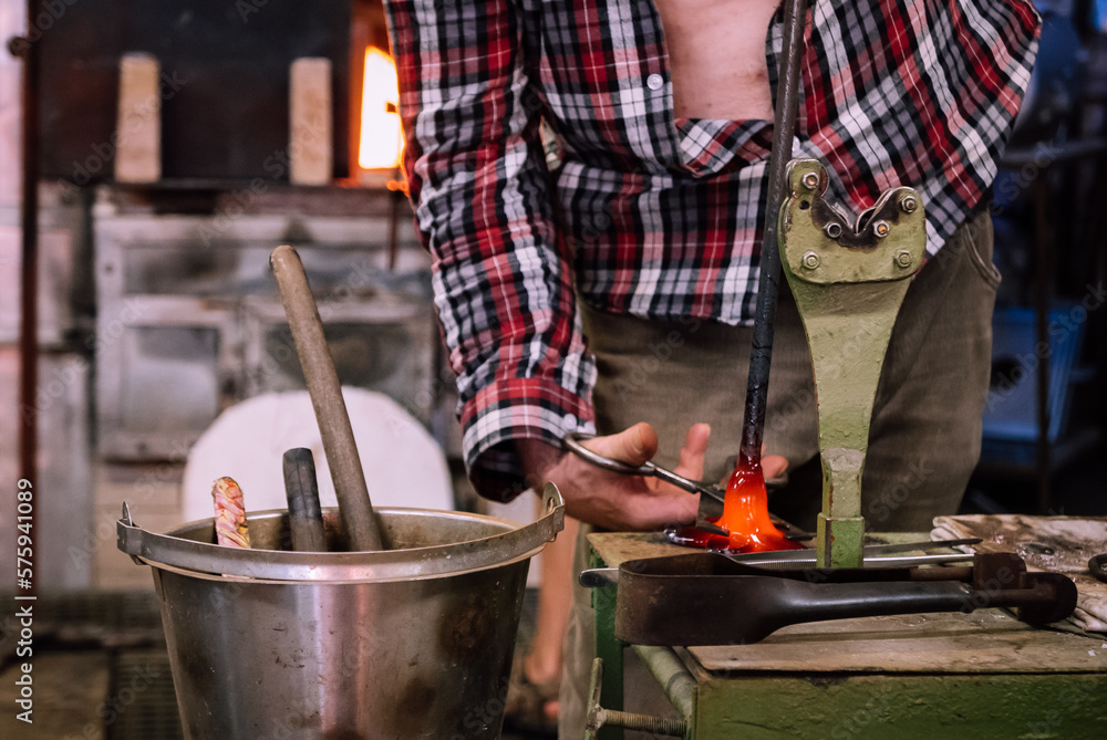A glassworks worker shows traditional methods of making decorative glass.