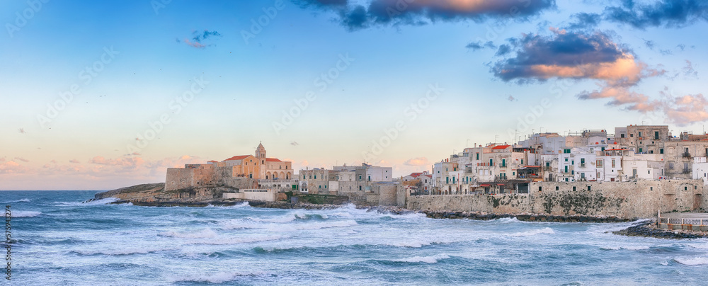 Breathtaking view of historic center and promenade of the city of Vieste at sunset