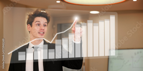 Happy man touching with finger a transparent screen with stock value.