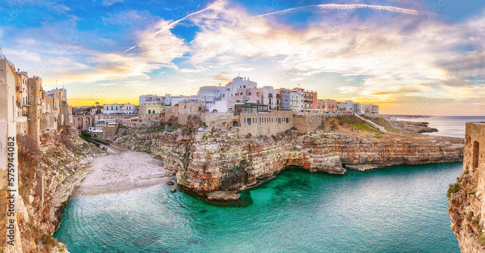 Stunning sunset at Cala Paura gulf with Bastione di Santo Stefano and Lama Monachile beach in background.