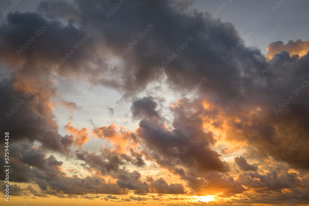 White fluffy cumulonimbus clouds forming before thunderstorm on evening sky. Changing stormy cloudscape weather at sunset White fluffy cumulonimbus clouds forming before thunderstorm on evening sky. Changing stormy cloudscape weather at sunset