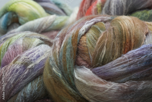 Closeup of lots of beautiful merino wheep wool  fibres in a roving ready for spinning yarn on a spinning wheel as a hobby photo