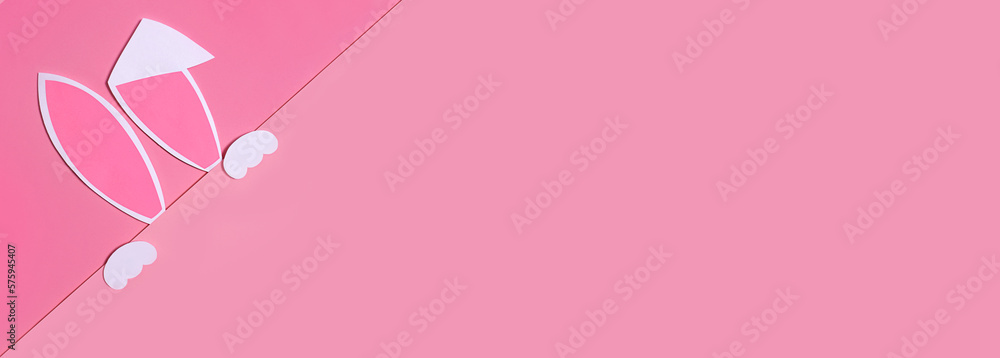 Easter background with rabbit ears on a pink background. The concept of Easter. Space for text. Banner.