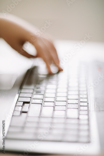 Close-up of male hands typing on laptop keyboard indoors. Businessman working in office or student browsing information. input data for information analysis and sending an email message