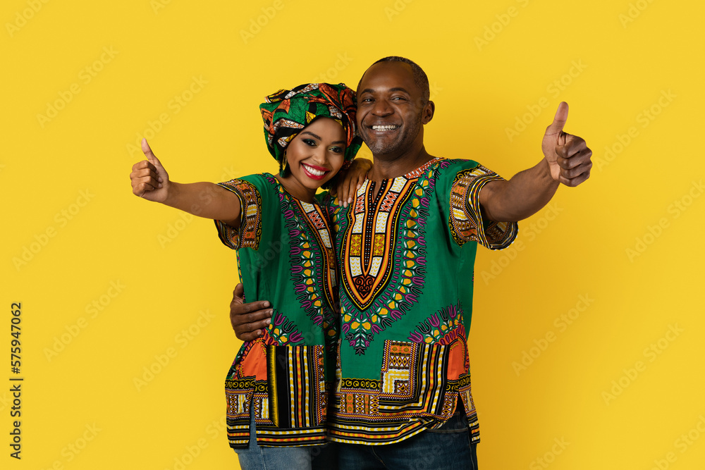 Obraz premium Cheery african husband and wife showing thumb ups