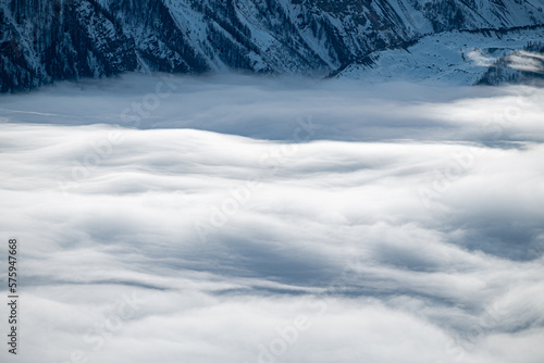 Panorama on Mont Blanc. Mountain wrapped in snow and white clouds.