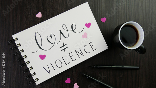 Bilde på lerret LOVE ≠ VIOLENCE lettering in notepad with pink hearts, cup of espresso and pens