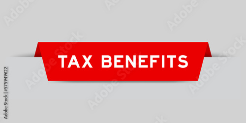 Red color inserted label with word tax benefits on gray background