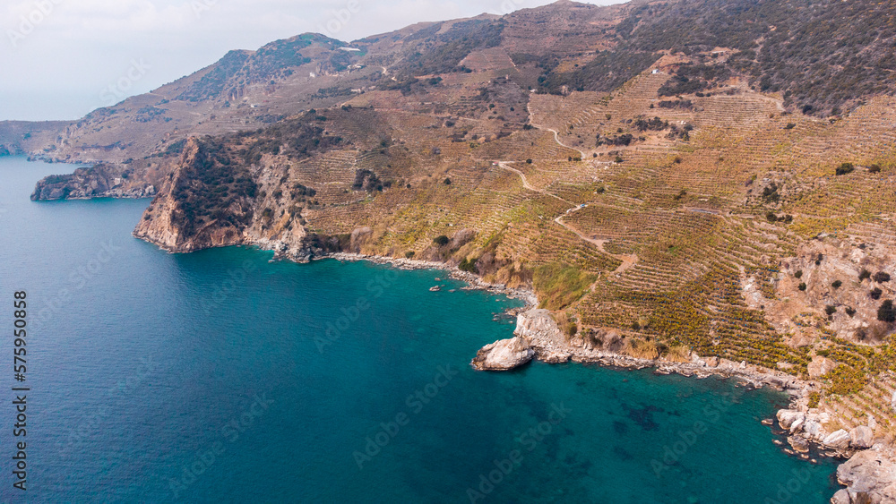 Turquoise bay and banana plantations on mountainside from a bird's-eye view. 