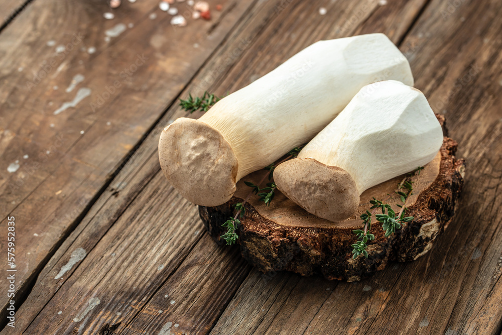 mushrooms king oyster or eringi on a wooden background, banner, menu, recipe place for text, top view mushrooms king oyster or eringi on a wooden background, banner, menu, recipe place for text, top view