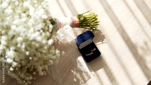 Wedding bouquet with white flowers and wedding rings