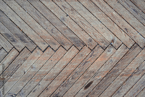 Old wooden terrace floor with herringbone flooring. Background texture.