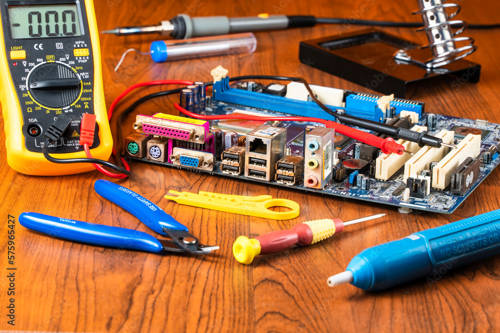 Repairing tools for malfunction computer mainboard on table. Fixing computer tools. Repairing tools for malfunction computer mainboard on table. Fixing computer tools.